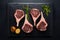 Fresh lamb chops on sleek black stone, culinary elegance