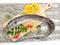 Fresh Largehead hairtail fish,Belt fish decorated with herbs and vegetables on a wooden pad.Selective focus