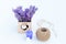 Fresh lavender in a small basket with heart, hemp ball, purple candle and white hearth bottle