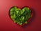 Fresh leaf salad on red heart shape plate