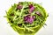 Fresh leaves of arugula and radicchio isolated on white background. Green bamboo salad bowl. Healthy food concept