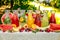 Fresh lemonade collection watermelon, orange, lemon, strawberry and berry in the street, on a wooden table with fruit