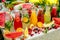 Fresh lemonade collection watermelon, orange, lemon, strawberry and berry in the street, on a wooden table with fruit