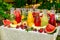 Fresh lemonade collection watermelon, orange, lemon, strawberry and berry in the street, on a wooden table with fruit