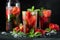 Fresh lemonade with ice, mint and strawberry on top in glass on black table background. Cold summer drink. Sparkling glasses with
