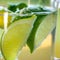 Fresh lemonade with slices of limes in a glass pot