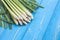 Fresh lemongrass or citronella grass leaf on blue wooden plank
