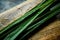 Fresh lemongrass or citronella grass on rustic wooden board. Herb used for healthy eating