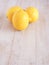 Fresh lemons fruit on white wooden background.