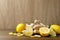 Fresh lemons and ginger on wooden table. Space for text