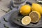 Fresh lemons and lemons leaves on rustic plate. Fresh citrus fruit background.