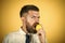 Fresh lemons. man with long beard eat lemon fruit on yellow background