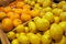 Fresh lemons and mandarin fruits on display in farmers market.