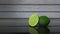 Fresh lime with a lime slice on a glass table selective focus