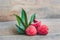 Fresh litchi fruit on an old wooden background