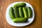 Fresh little cucumbers in a plate, mini gherkins