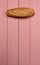 Fresh loaf of gluten free bread on pink background