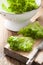 Fresh lollo salad leaves on chopping board for salad