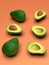 Fresh looking green avocado fruits, whole and cut in half, on pink