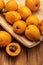 Fresh loquats medlars on wooden background. Rustic and healthy appearance.