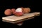 Fresh lychee fruit isolated on black glass