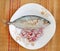 Fresh mackerels with onion in dish