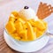 Fresh mango shaved ice with a scoop of ice cream and juice sauce in summer restaurant, lifestyle, popular food in Taiwan, close up