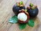 Fresh mangosteen fruit on wood