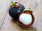 Fresh mangosteen fruit on wood