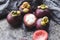 Fresh mangosteens on the dark background