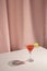 fresh margarita cocktail drink with lemon slice table against pink curtain. High quality photo