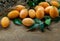 Fresh marian plums sweet yellow or mayong-chit with green leaf on the wooden background