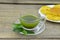 Fresh matcha tea in cup with pineapple jam on wooden table