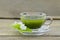 Fresh matcha tea with jasmine in cup on wooden table