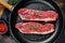 Fresh meat, marbled beef, raw New York strip steak. Dark background. Flat lay