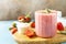 Fresh milk, strawberry drinks on wooden board on a stone background, protein shake with fresh berries. Copy space