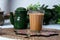 Fresh milk tea or indian karak chai in glass with chanak on white background. top view