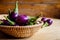 Fresh mini purple eggplant in the basket on wooden background