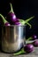 Fresh mini purple eggplant in stainless cup on wooden background