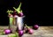 Fresh mini purple eggplant in stainless cup on wooden background