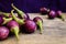 Fresh mini purple eggplant on wooden background