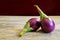 Fresh mini purple eggplant on wooden background