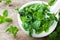 Fresh mint leaves in mortar bowl.