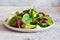 Fresh mix of salads: lettuce, arugula, spinach, mesclun, mache on a dark background