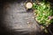 Fresh mixed green salad with oil dressing rustic wooden background, top view. Healthy food