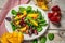 Fresh mixed salat with of fresh lettuce, mango, pomegranate and sesame on plate. Diet menu. Food background Top view