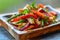 Fresh Mixed Vegetable Stir Fry Dish with Bell Peppers, Onions, and Herbs Served on Wooden Plate Healthy Vegan Cuisine