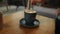 Fresh morning coffee close-up. A man stirs sugar in a cup of aromatic coffee close-up. Male hand stirs a cup of hot