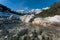 Fresh mountain river flowing over rocks through sunny evergreen forest, Mieminger Plateau, Tirol, Austria