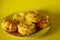Fresh muffins on exquisite traditional plate on yellow backround